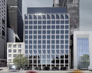 UN Plaza facade renovation in Manhattan showing vertical terracotta and glass panels with flowing wind-inspired patterns on the Permanent Mission of Qatar building